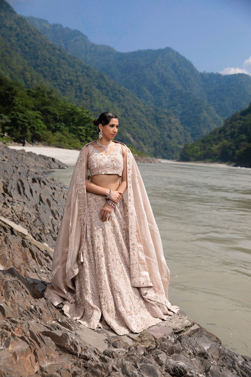 Champagne gold lehenga featuring intricate floral embroidery for an effortlessly regal statement