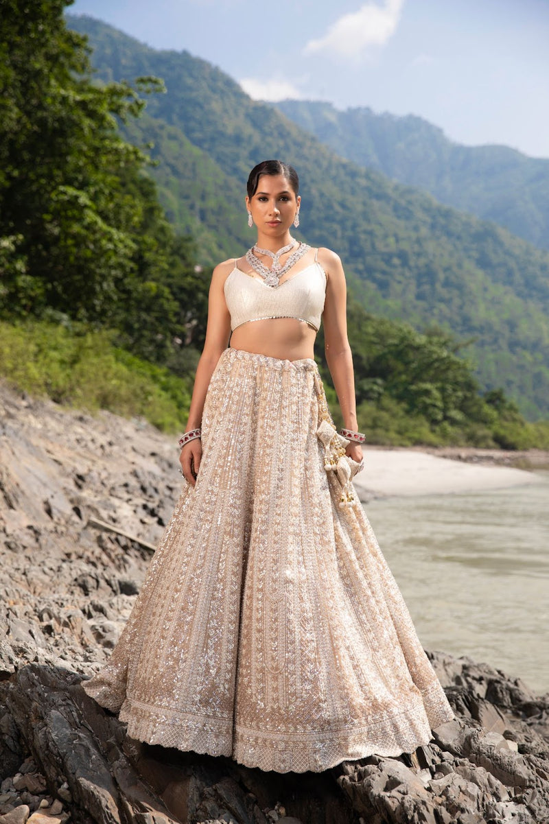 An eye catching ivory lehenga that encapsulates the luminous elegance.